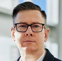 Executive portrait of Alexander Hughes, CEO of a cryptocurrency trading company